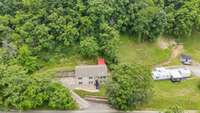 Drone view capturing the property nestled in a peaceful country setting.