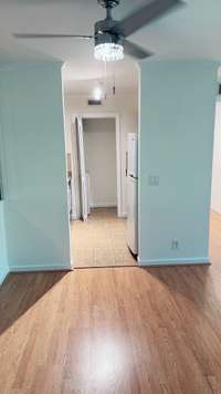 Another view, as you step in the front door, looking into the kitchen. The freshly painted wall color is actually a bright white, but looks slightly bluish in certain light!
