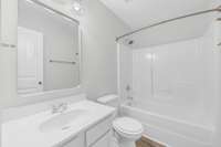 Full size bath with new mirror, tub/shower combo