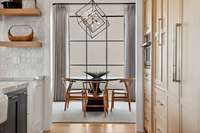 The breakfast room located off the kitchen with floor to ceiling windows