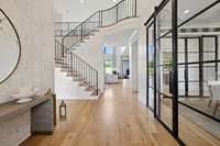 Entering the home you are greeted by lovely natural hardwoods, to the right is the dining room