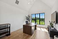 Bedroom #2 has tall ceilings and natural wood floors