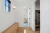 A storage bench in the space between the bedroom and closest/bath spaces