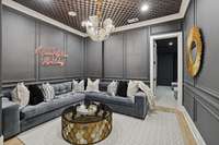 With a speakeasy vibe, this cozy corner invites the best conversations! Door is access to the theater room