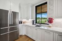 The butler's pantry has additional refrigerator/freezer, extensive storage and an appliance lift