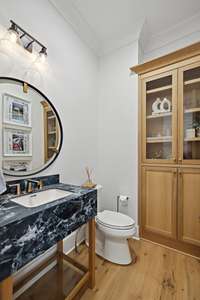 Powder room in hallway near office