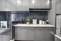 A jetted sink allows for hand washing delicate clothes. Quartz countertops