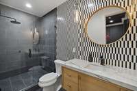 The basement bathroom has a fully tiled shower
