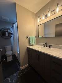 Half Bath with Custom Vanity  with fashionable lighting and decor