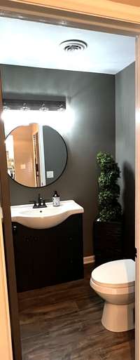 Half Bath downstairs with hardwood flooring; Renovated and Updated