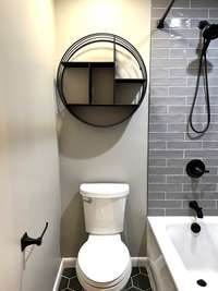 Bath upstairs with tub/shower combo and tile surround ;