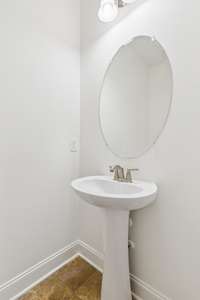 Half bath located in the hall near the front door, dining room and living room.