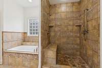 Oversized tub and huge walk-in shower.  To the right of the shower is the walk-in closet.  To the left of the tub is a linen closet.
