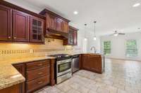 Beautiful cabinetry with seeded glass windows, arched vent hood, custom spice drawers (pull out turned legs next to the stove). Tons of drawers and door storage.  Beautiful gas range with a pot filler in the back wall.