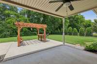 Covered back yard and a pergola on the extended concrete patio.  Large corner lot with fencing on North side, West side has a mature treeline for privacy.