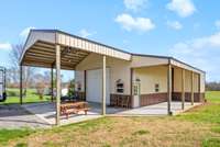 This 30x40 shop is insulated and climate controlled. Also has a 10x10 garage on back side that would hold your lawn mower or for more storage. 20' overhang on front 10' overhang on side porch for an additional entertainment area.