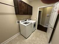 Laundry room off the garage and next to the main bedroom