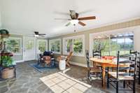 Fully finished sunroom w/ real stone floors overlooks expansive back acreage