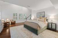 large set of windows overlooks the backyard, above the suite is an open loft space that could be an additional seating area or home office