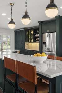 Designer lighting hangs above the island eating area