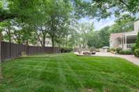 Wonderful level yard space under the shade of mature trees would be perfect for a putting green!