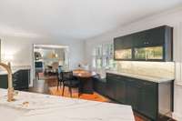 The kitchen has sleek quartz counters and a solid quartz backsplash