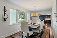 A formal dining. room with a picture window overlooking the front lawn