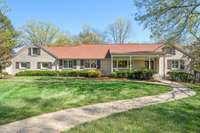 Sprawling West Meade ranch on nearly an acre, featuring impressive curb appeal and mature landscaping in a great location, close to West Nashville, Belle Meade and Green Hills