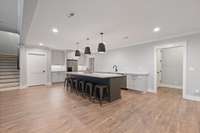 Kitchen area includes a sink, fridge, and dishwasher.