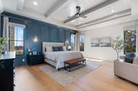 Primary Suite on the Main Floor offers plenty of room to relax and features wood beams in the ceiling and calming color theme.