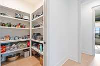 Walk-in pantry with a pocket door and has 4 appliance outlets!