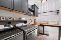 Main laundry room with storage, folding station, hanging rack and custom crate!
