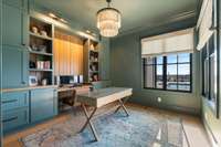 Beautiful custom office on the main floor looking out onto the pool!