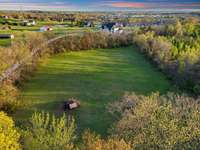 Cleared area on the property just under 3 acres is surrounded by trees! Don't over look it on your tour!