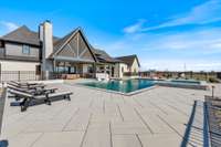 True oasis! Gunite salt-water sports pool and spa with tanning ledge. Outdoor Kitchen with Napoleon and True appliances, gas fireplace, fire pit, and a designated outdoor bathroom!