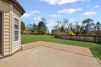 Large back patio and flat back yard.