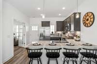 The open-concept kitchen features a bar with ample space for dining & lots of cabinet space.