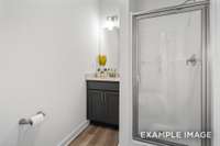 This home features 3 full bathrooms; shown here is the main-floor bath complete with a walk-in shower.