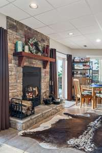 Stacked stone fireplace is wood burning for those chilly evenings. Cozy up here to read a good book.