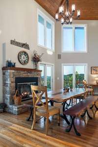 Stacked stone fireplace for those cool nights at the lake. View from the great room toward the kitchen/dining areas.