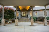 This entryway will welcome your guests with style. Note the beautiful stonework and lush landscaping.