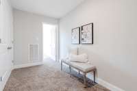 Upstairs landing area between bedrooms features utility closet & linen closet.