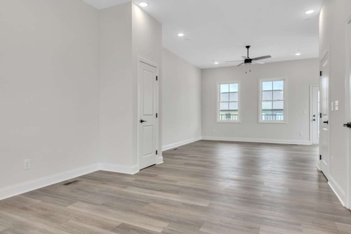 The dining area is conveniently located at the top of the stairs between the open floor plan kitchen and spacious living space. There is an additional pantry closet on the left and a coat closet on the right in photo.