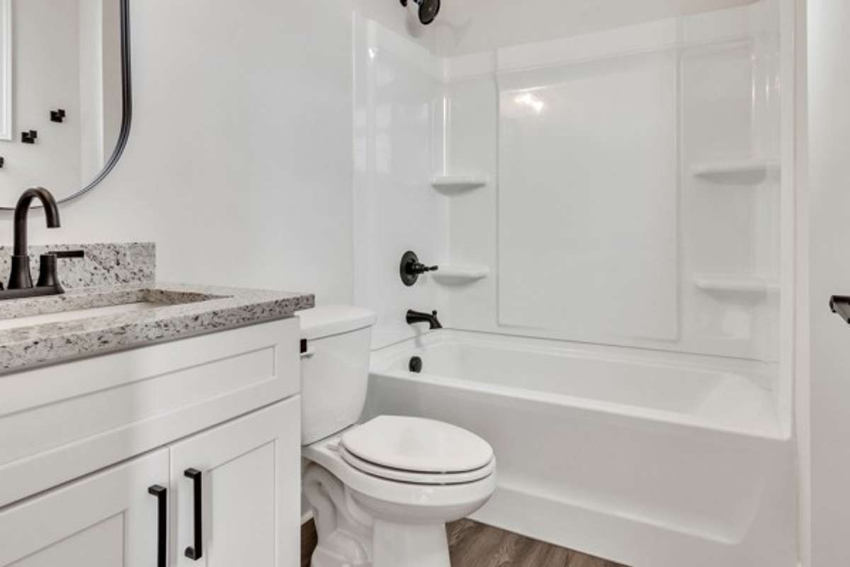 Private bath for guest room with window for added natural light.