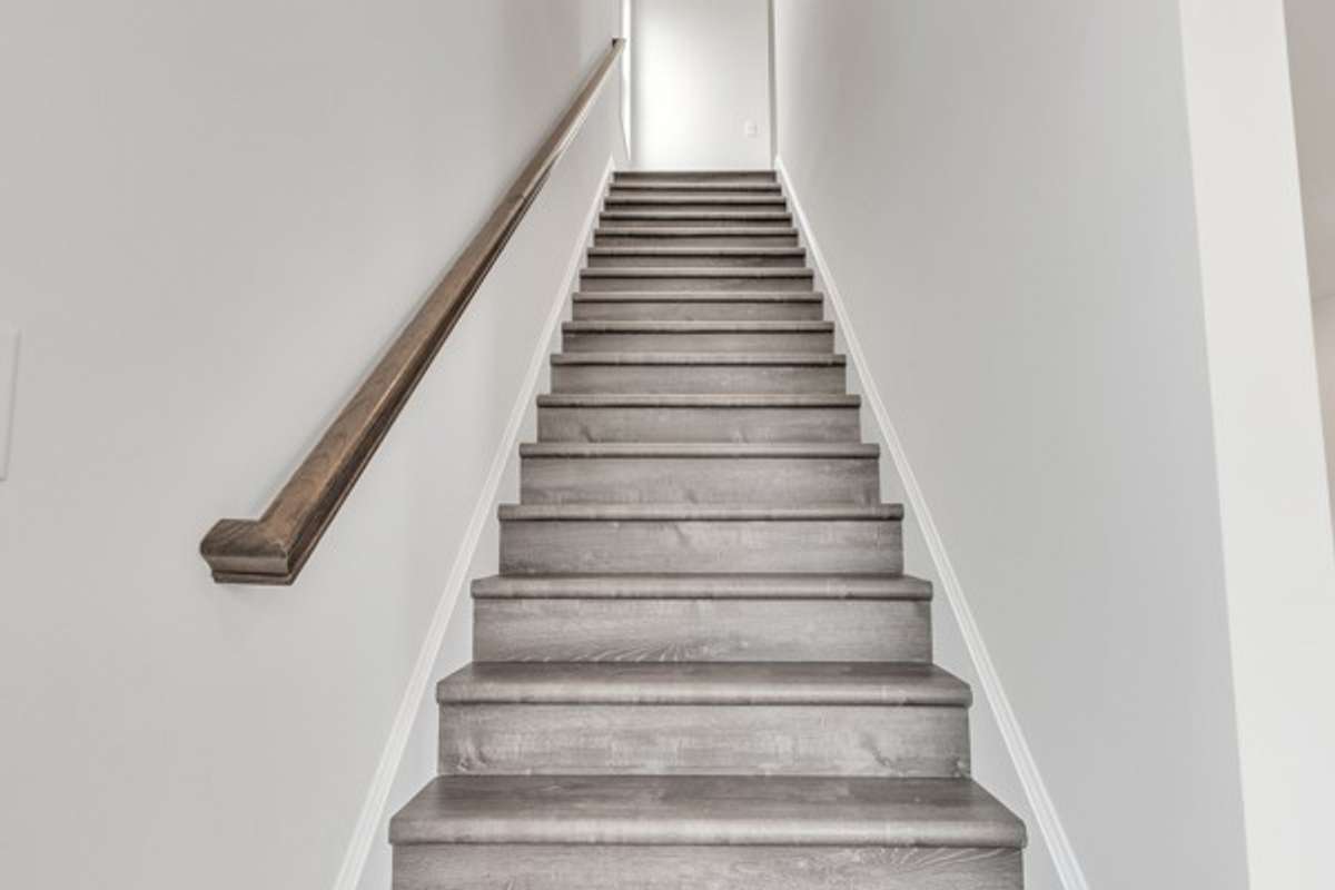 Beautiful hard wood stairs to the 3rd floor where you will find the laundry room along with the primary and 2nd guest bedrooms. (Both with private baths)