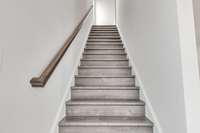 Beautiful hard wood stairs to the 3rd floor where you will find the laundry room along with the primary and 2nd guest bedrooms. (Both with private baths)