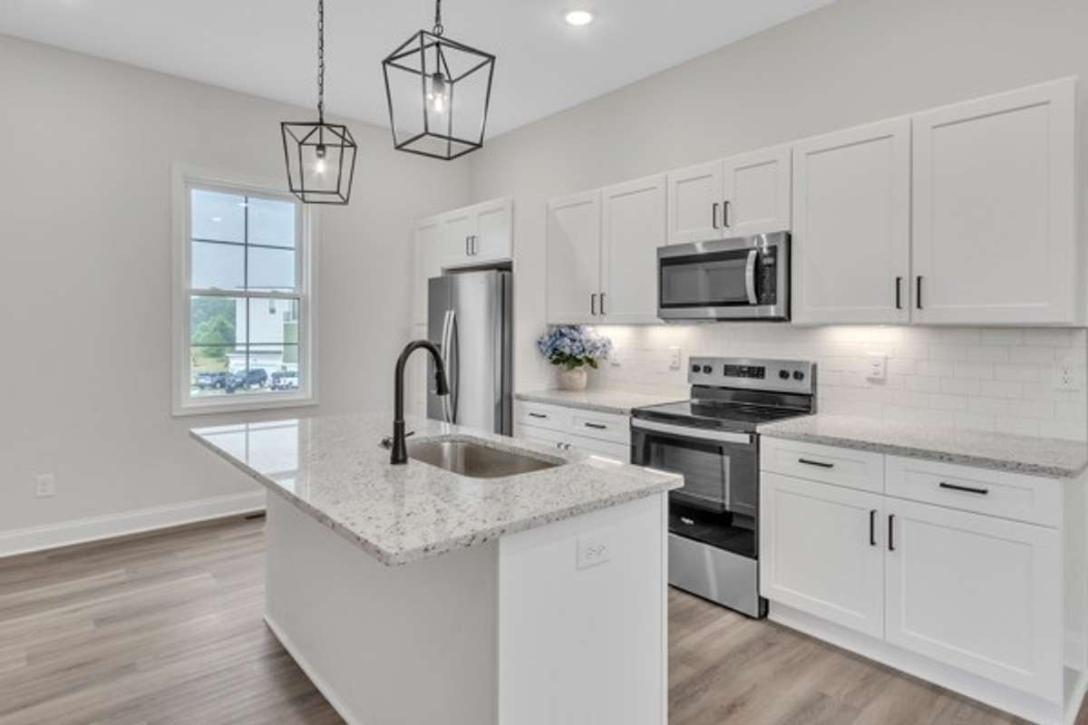 This kitchen is so bright and friendly with multiple light sources including the pendants, recessed lighting, under cabinet lighting and large window to let natural light stream in.