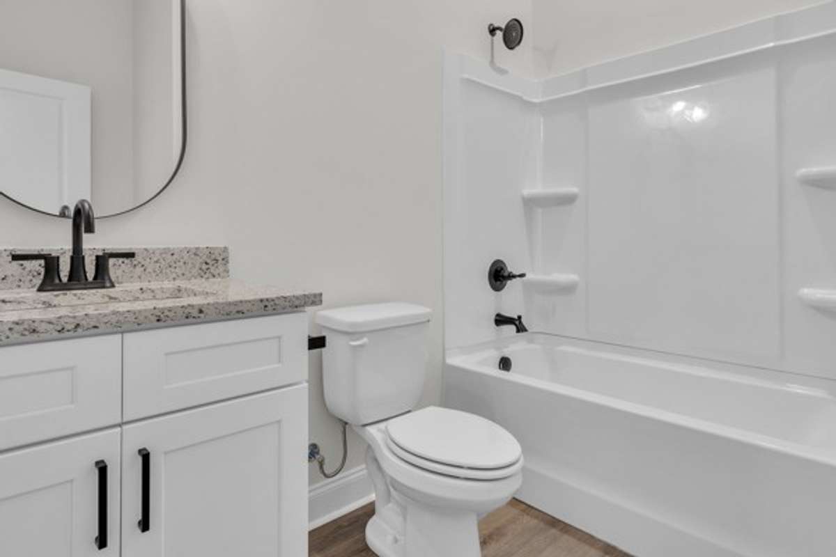 1st floor full bathroom for use by 1st floor guest room and easy access from garage and front door foyer area.