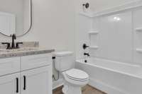 1st floor full bathroom for use by 1st floor guest room and easy access from garage and front door foyer area.