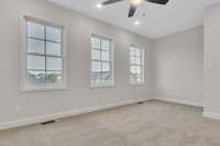 A shot of the blue skies through the 3 primary suite windows and room for a reading area for added comfort!